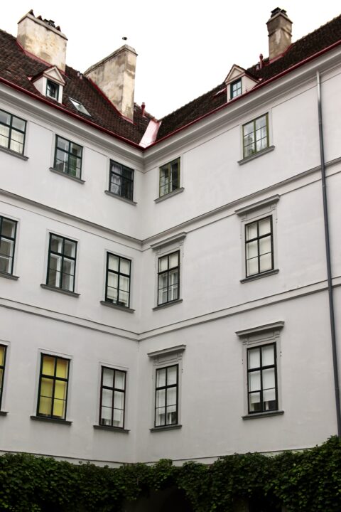 corner of historic european building with symmetrical windows – ideal for architectural design and urban development projects. vienna, austria