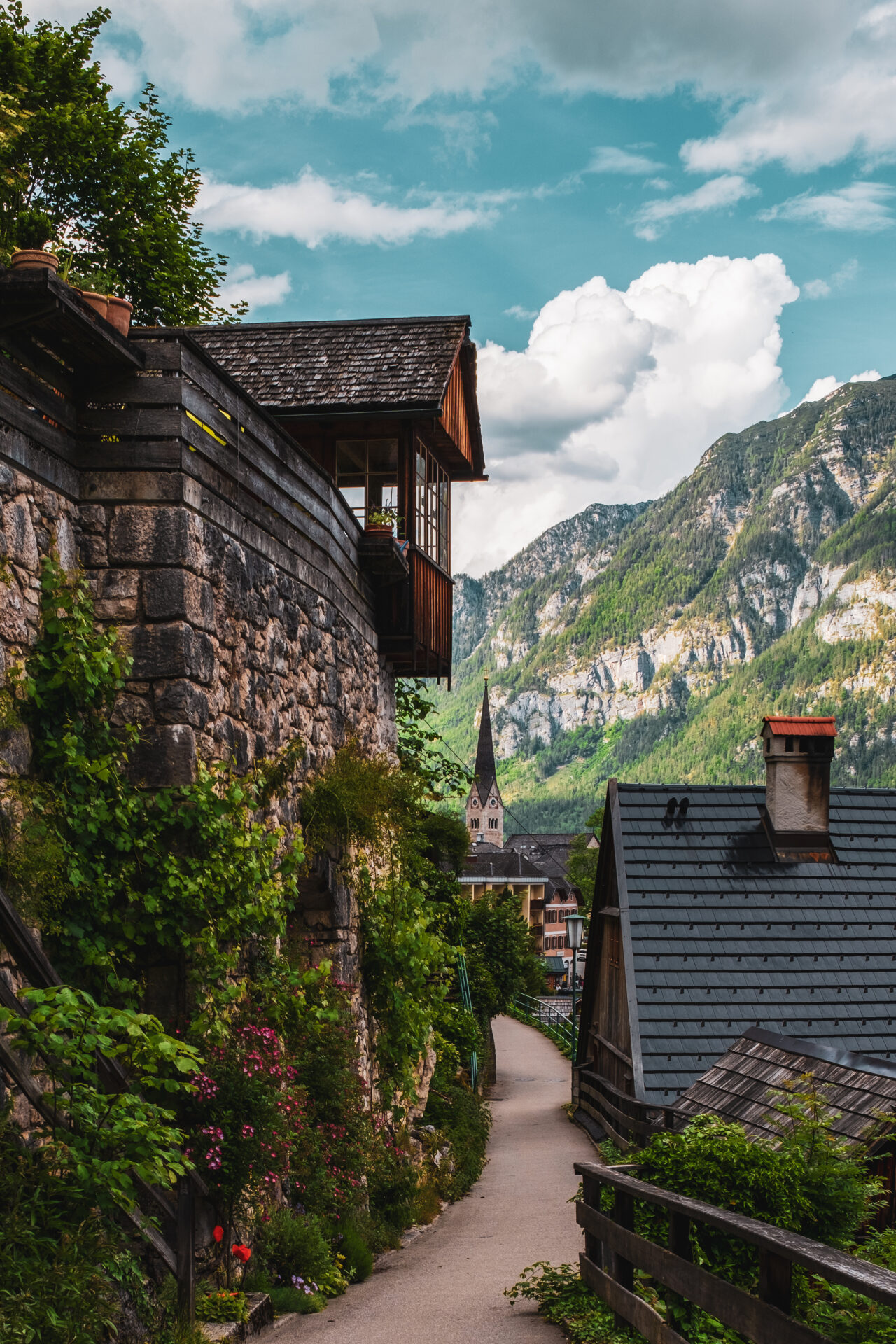 village path with old wooden houses in hallstatt, austria.